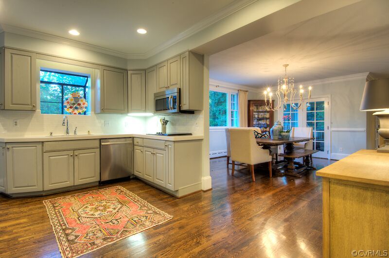 6805 River Road Henrico, VA 23229 - Photo 8 of 24 a kitchen with a sink dining table and chairs