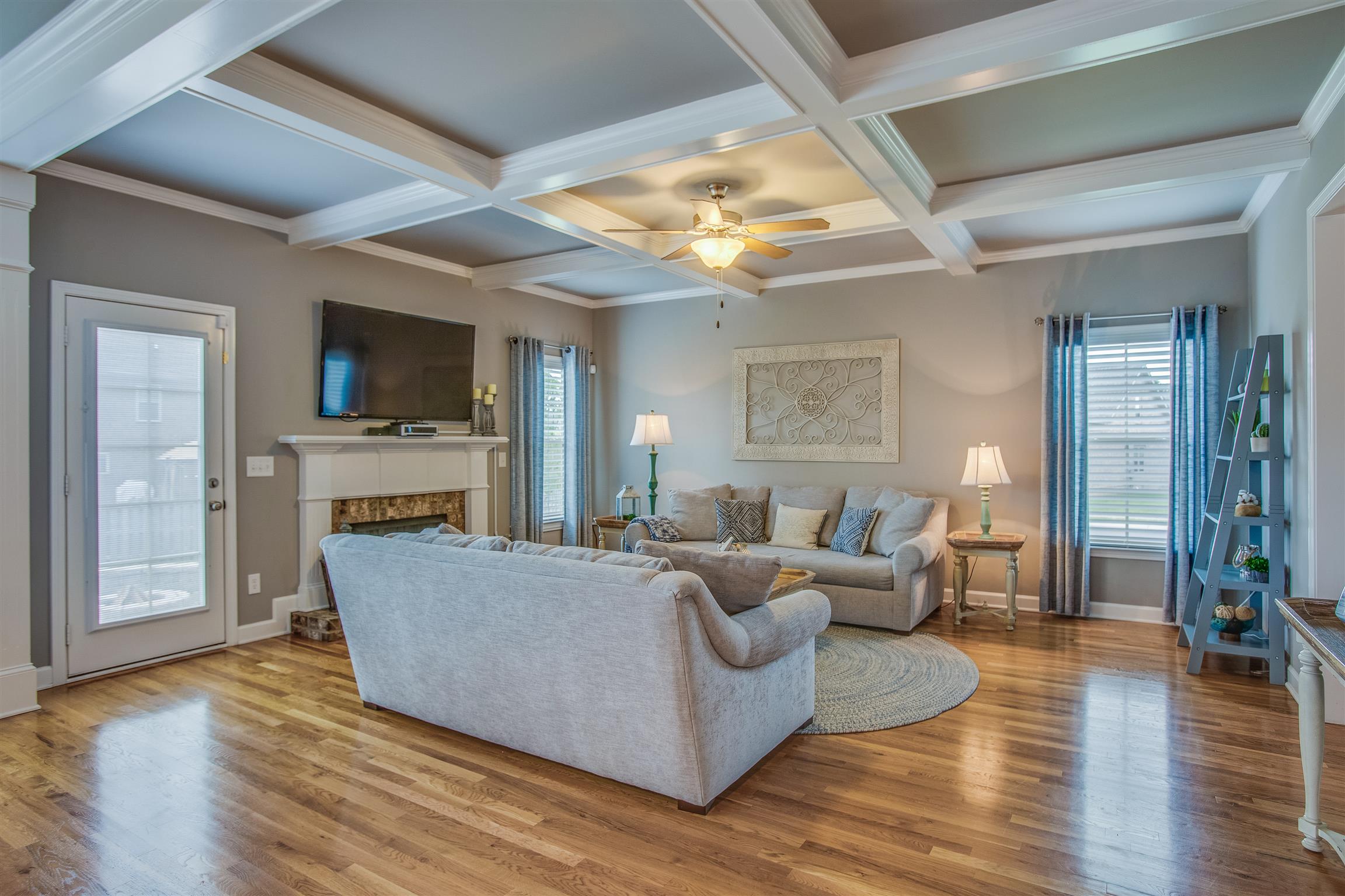 Designer color paint throughout beautifully accent the well appointed home, including a coffered living room ceiling and crown molding throughout  