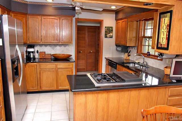 113 Queensferry Road Cary, NC 27511 - Photo 3 of 9 a kitchen with stainless steel appliances a stove a sink and cabinets