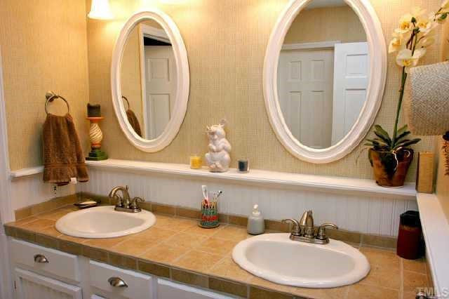 113 Queensferry Road Cary, NC 27511 - Photo 6 of 9 a bathroom with a sink and a mirror