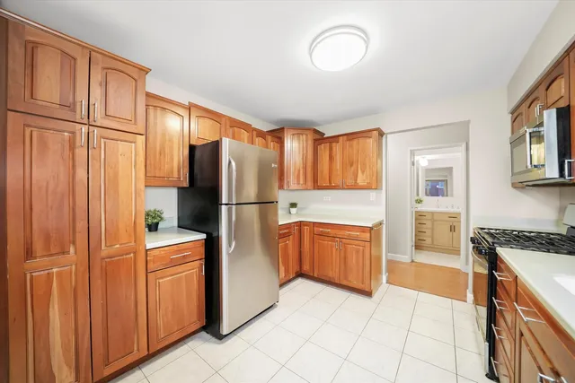 a kitchen with granite countertop a refrigerator stove top oven and sink