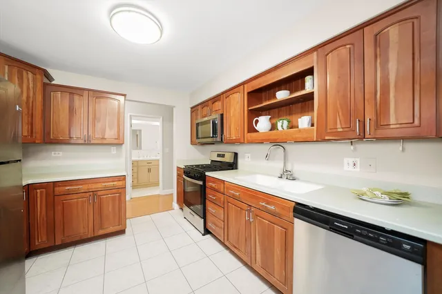 a kitchen with stainless steel appliances granite countertop a sink stove and cabinets