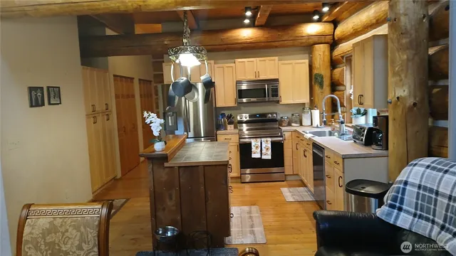 a kitchen with stainless steel appliances kitchen island granite countertop a sink and cabinets