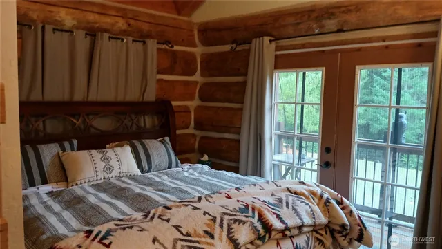 a bedroom with a bed and a window