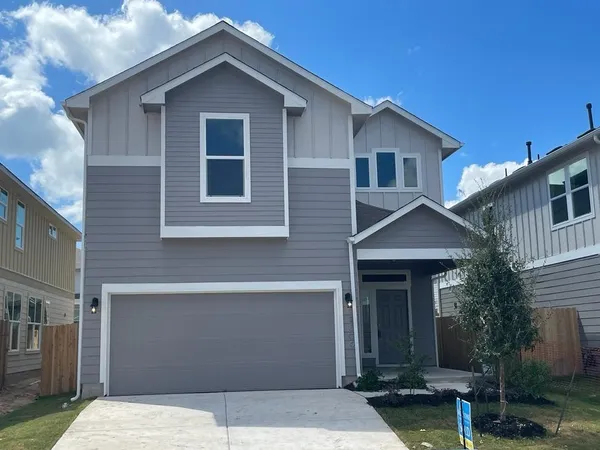 a front view of a house with garage