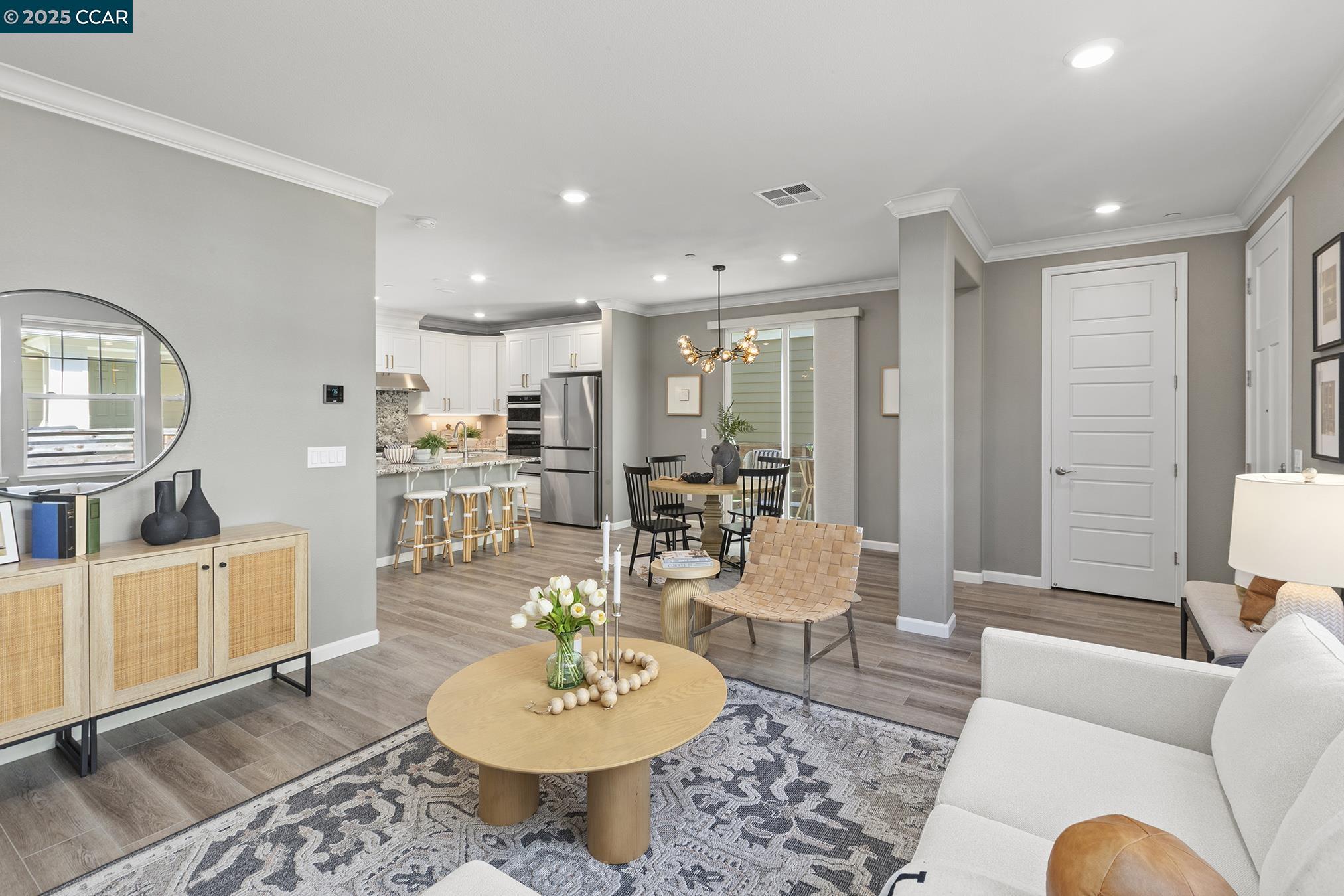 a living room with furniture kitchen view and a table