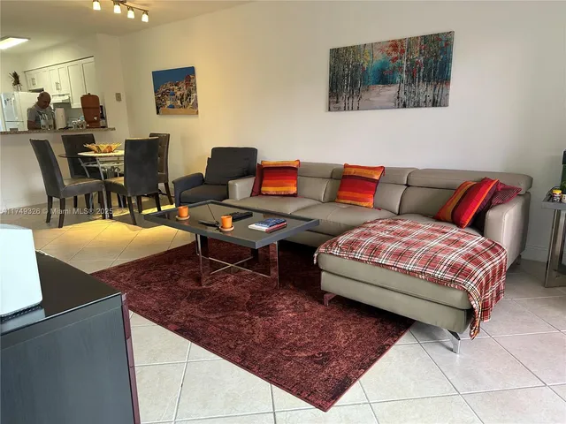 a living room with furniture and a rug