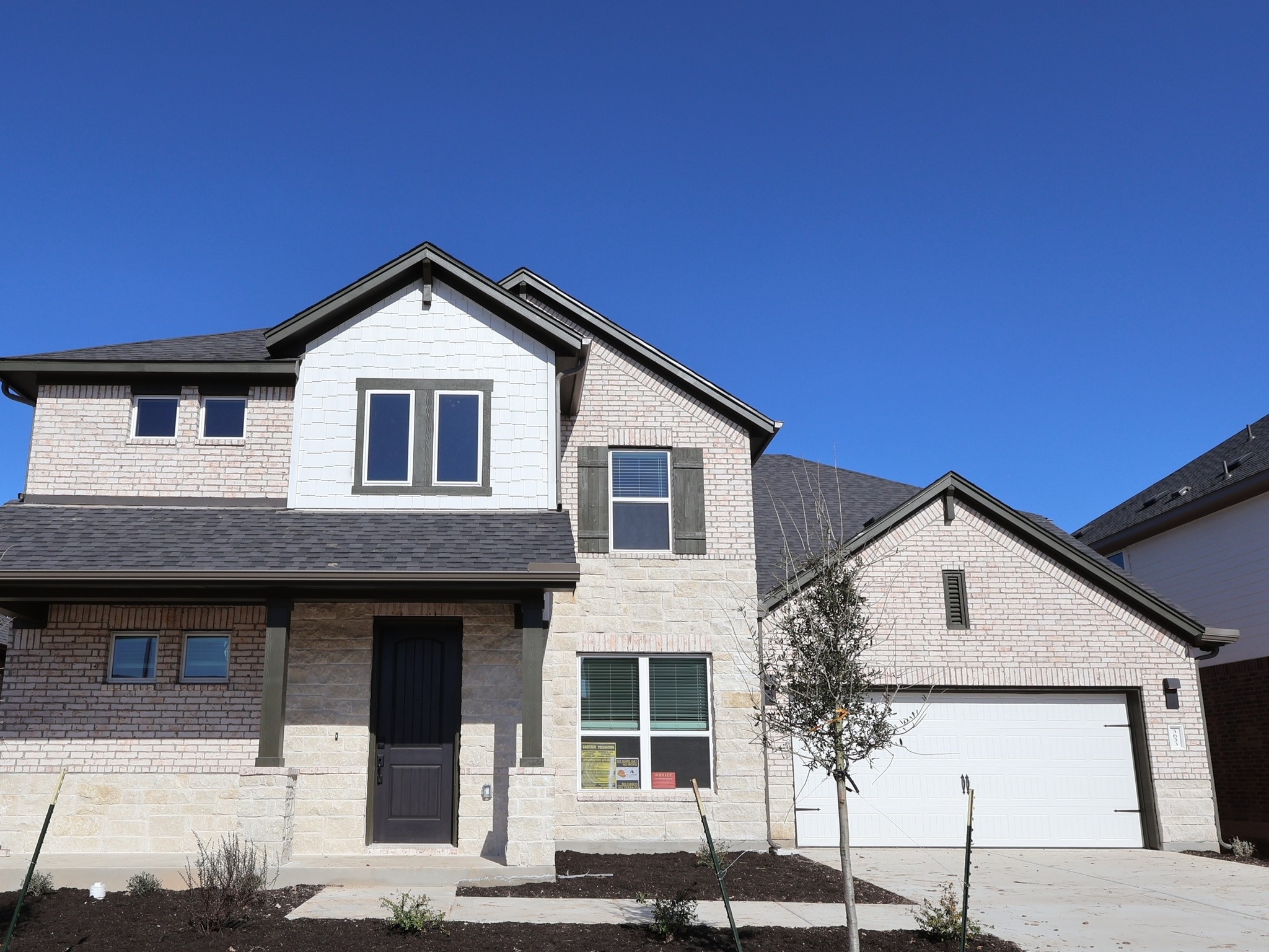 a front view of a house with garage