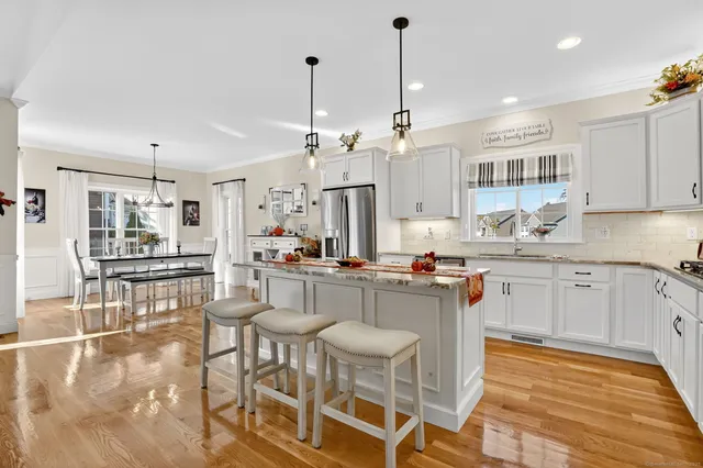 a kitchen with stainless steel appliances kitchen island granite countertop a sink and cabinets