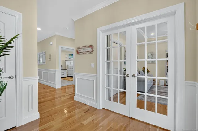 a view of a big room with wooden floor and windows