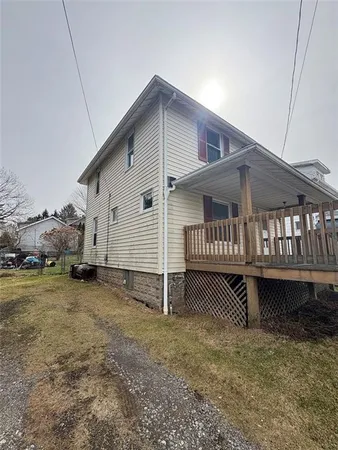 a view of a house with wooden deck front of house