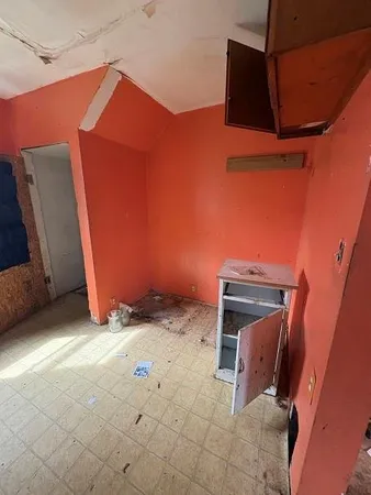 a backyard of a house with yard and wooden fence