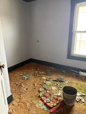 a view of water heater room with toilet