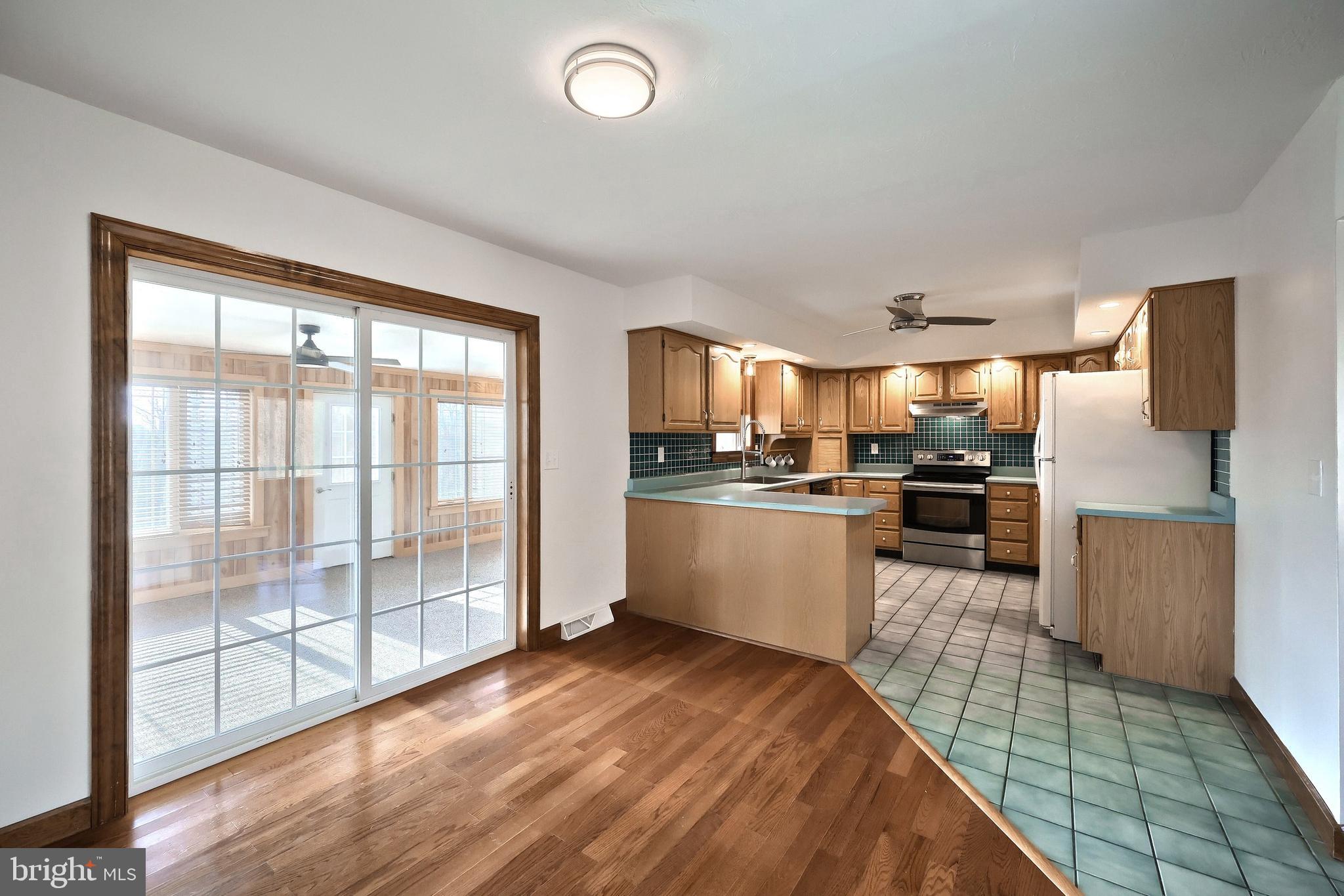 90 Vida Lane Dover, PA 17315 - Photo 13 of 59 a kitchen with stainless steel appliances granite countertop a stove top oven a sink dishwasher a refrigerator and white cabinets with wooden floor