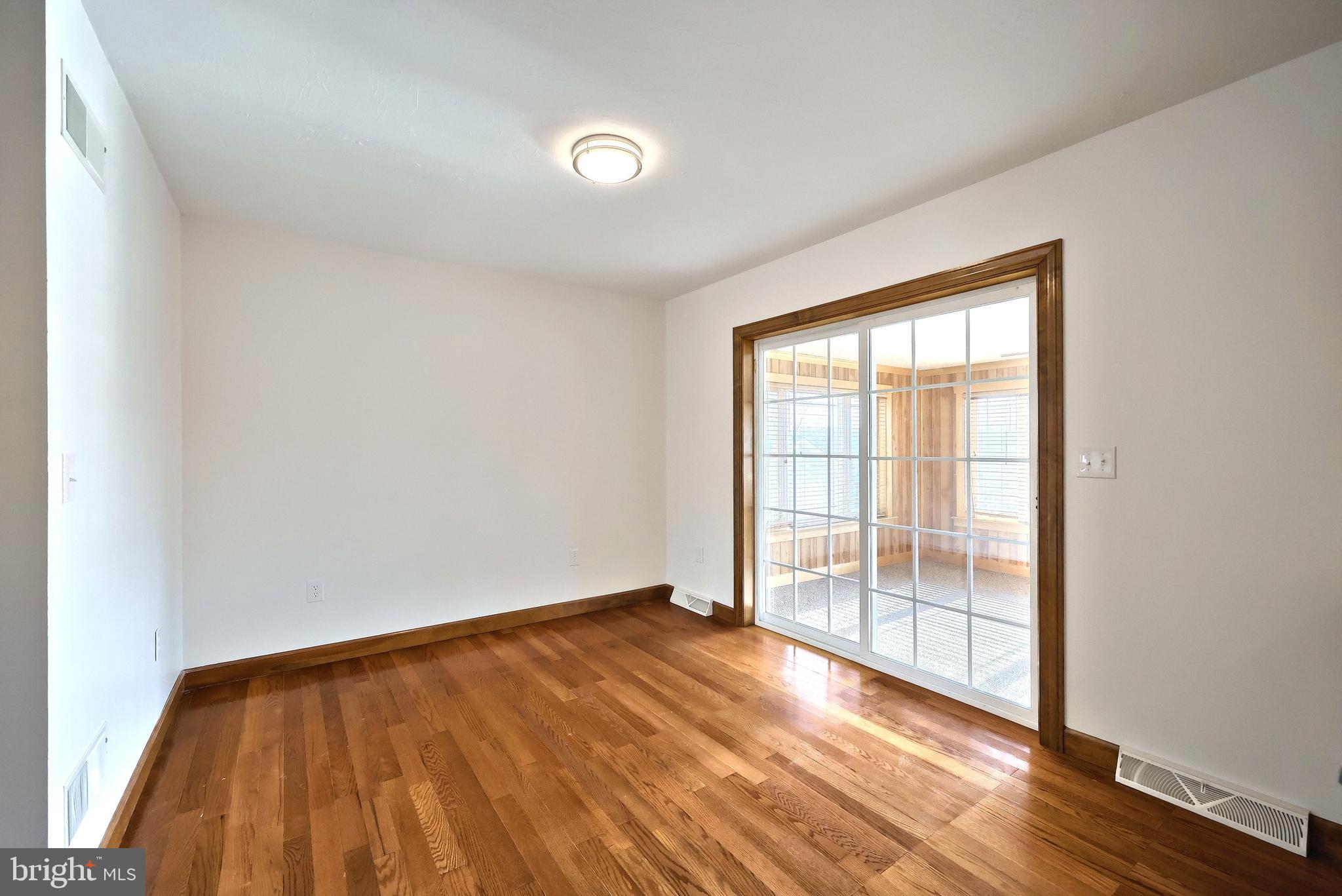 90 Vida Lane Dover, PA 17315 - Photo 14 of 59 an empty room with wooden floor and windows