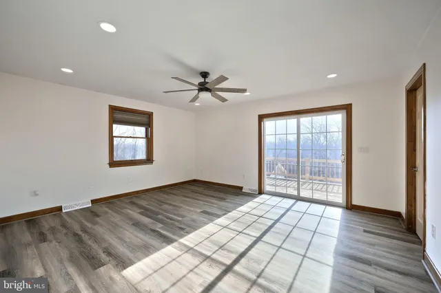 a view of a livingroom with a ceiling fan and window