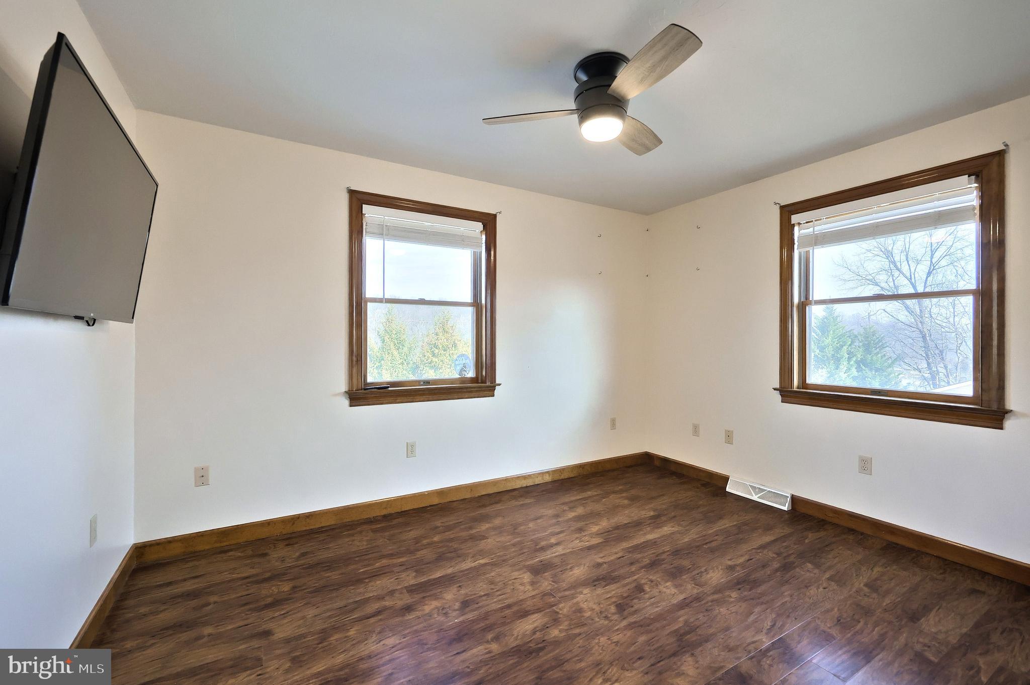 90 Vida Lane Dover, PA 17315 - Photo 25 of 59 a view of empty room with wooden floor and fan