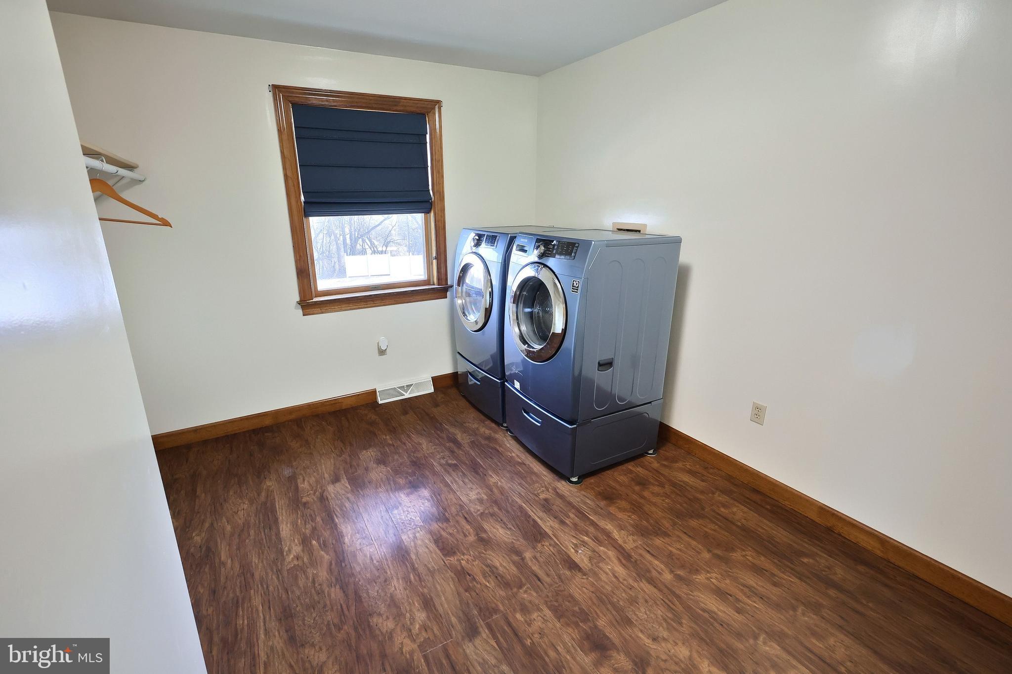 90 Vida Lane Dover, PA 17315 - Photo 26 of 59 a view of walk in closet with window and hardwood floor