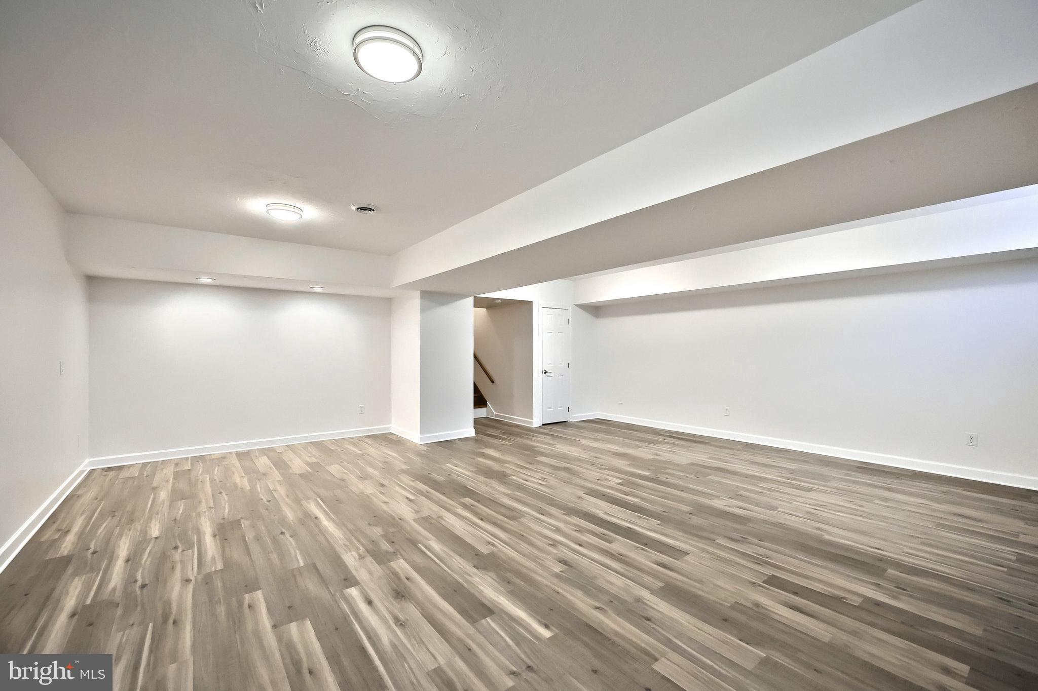 90 Vida Lane Dover, PA 17315 - Photo 28 of 59 an empty room with wooden floor and windows