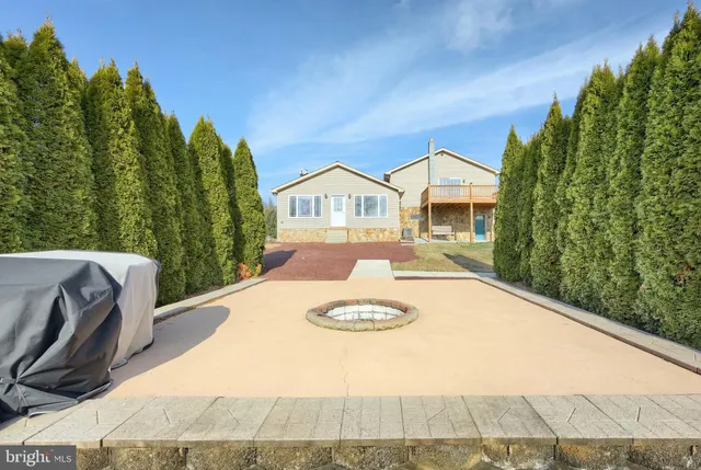 a view of a house with a yard and pathway