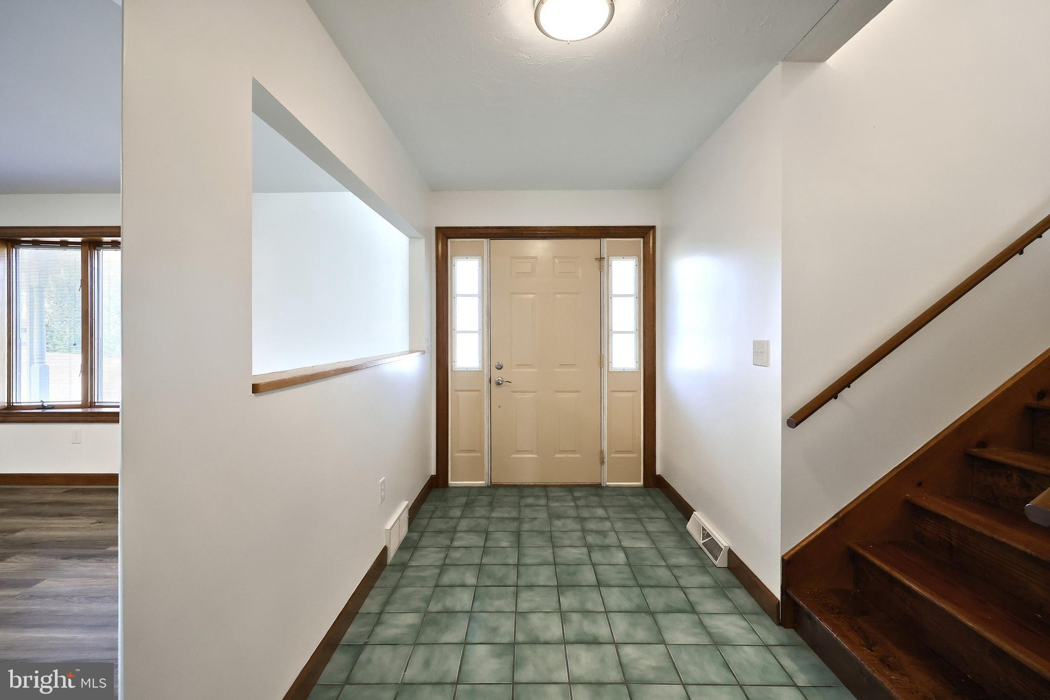 90 Vida Lane Dover, PA 17315 - Photo 6 of 59 a view of a hallway with wooden floor and staircase