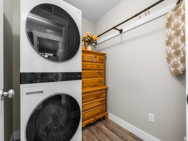 7 Sterling Loop Vineyard, UT 84059 - Photo 28 of 43 Dedicated laundry area featuring modern stacked appliances, wood-finish flooring, and light gray wall paint