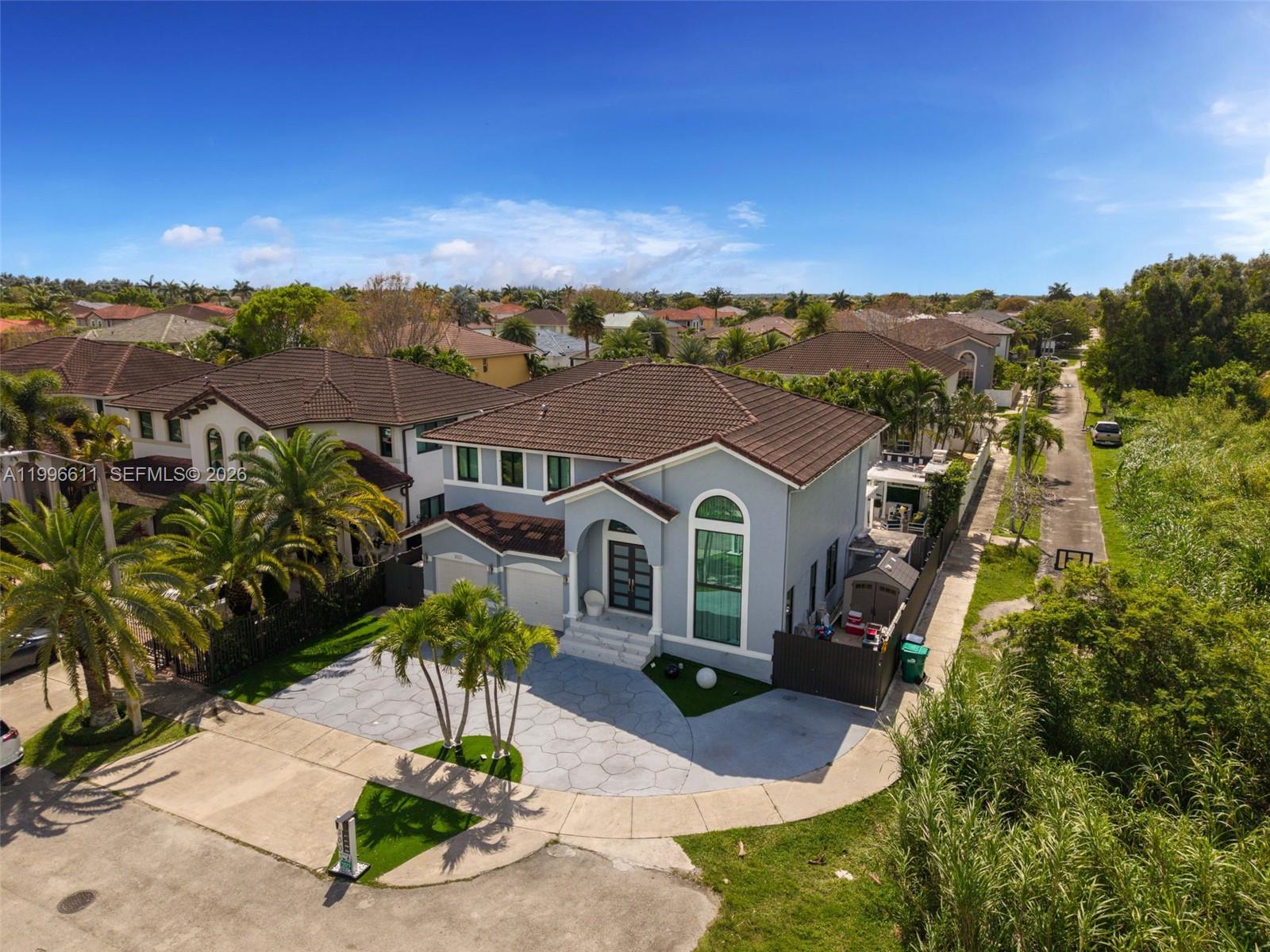 3002 Southwest 147th Court Miami, FL 33185 - Photo 12 of 97 an aerial view of a house with a yard and lake view