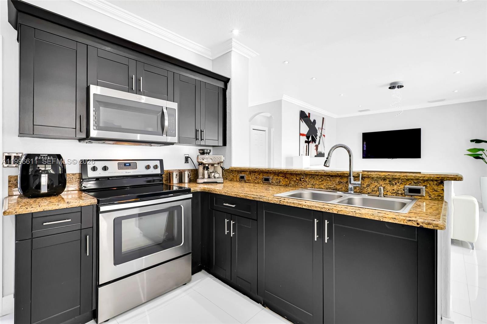 3002 Southwest 147th Court Miami, FL 33185 - Photo 22 of 97 a kitchen with stainless steel appliances granite countertop a sink stove and microwave