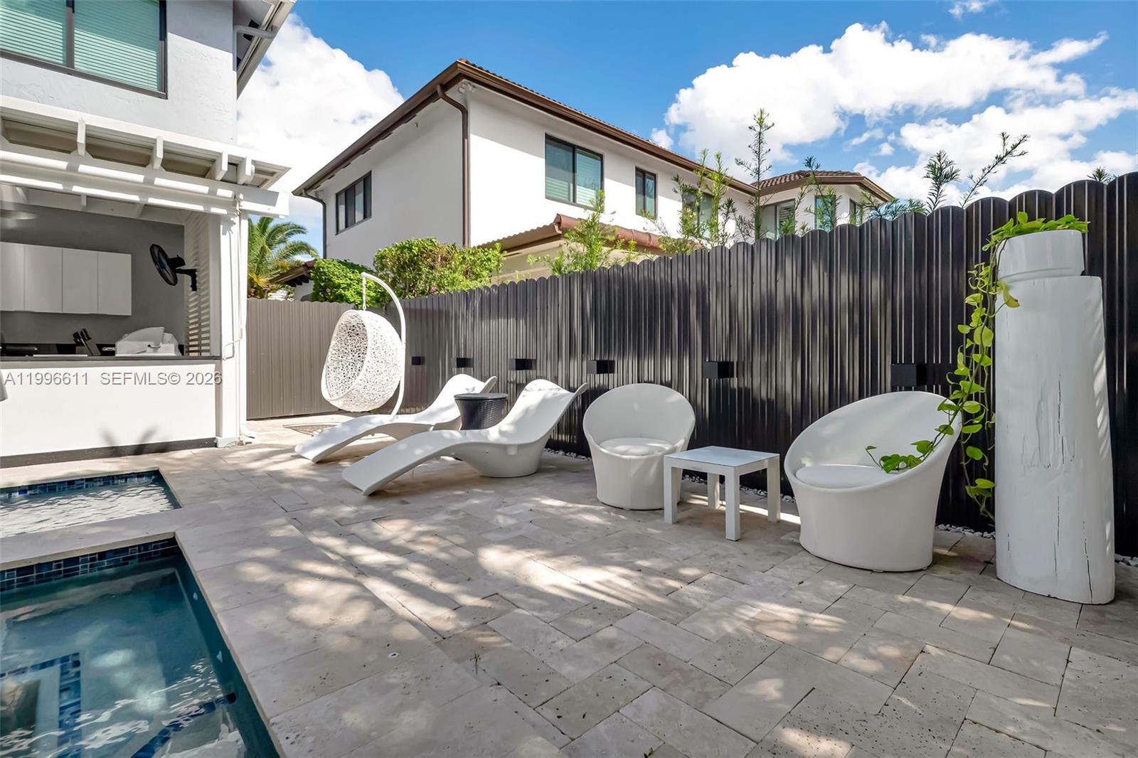 3002 Southwest 147th Court Miami, FL 33185 - Photo 34 of 97 a backyard of a house with table and chairs