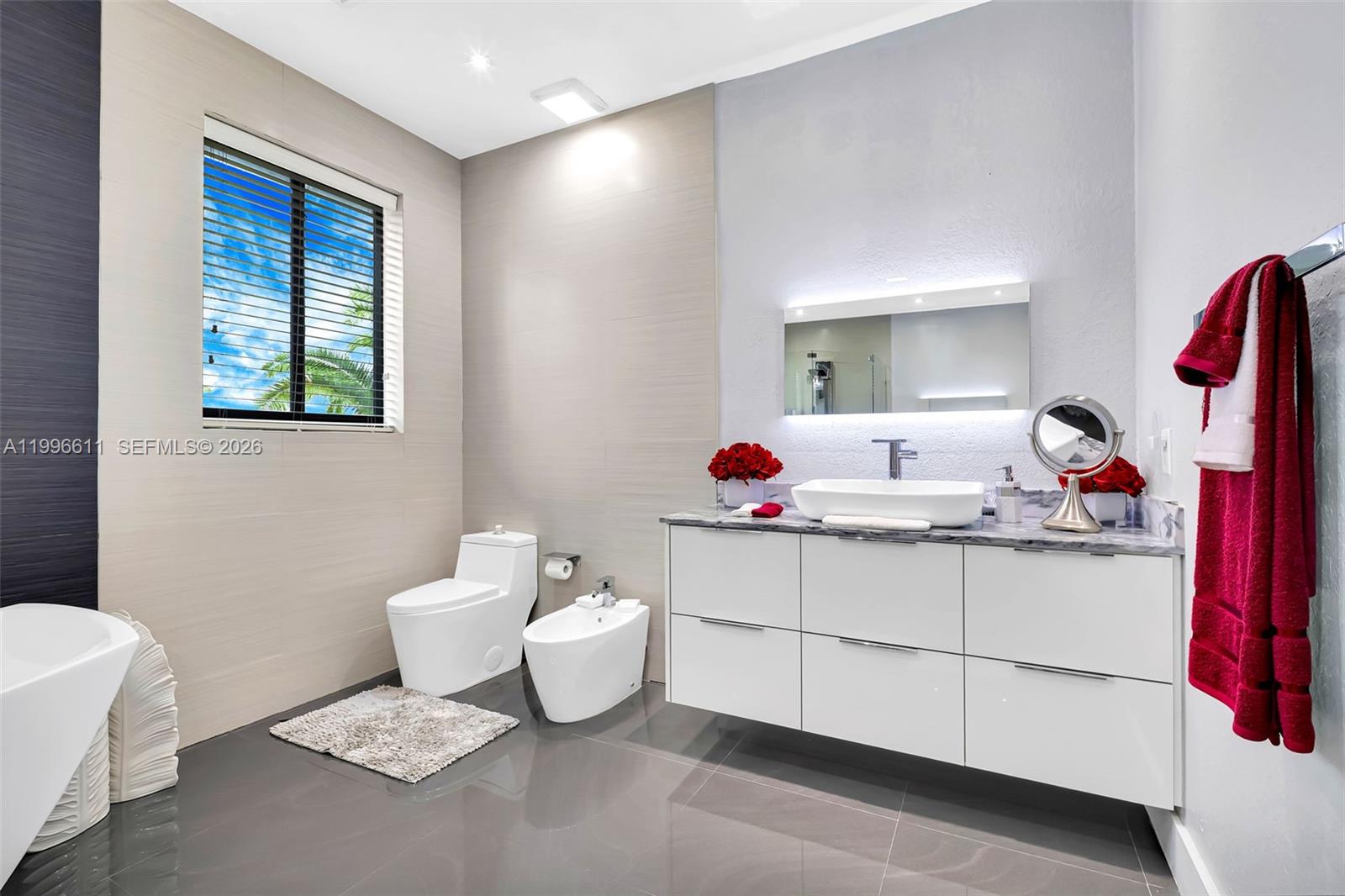 3002 Southwest 147th Court Miami, FL 33185 - Photo 51 of 97 a bathroom with a sink toilet and mirror