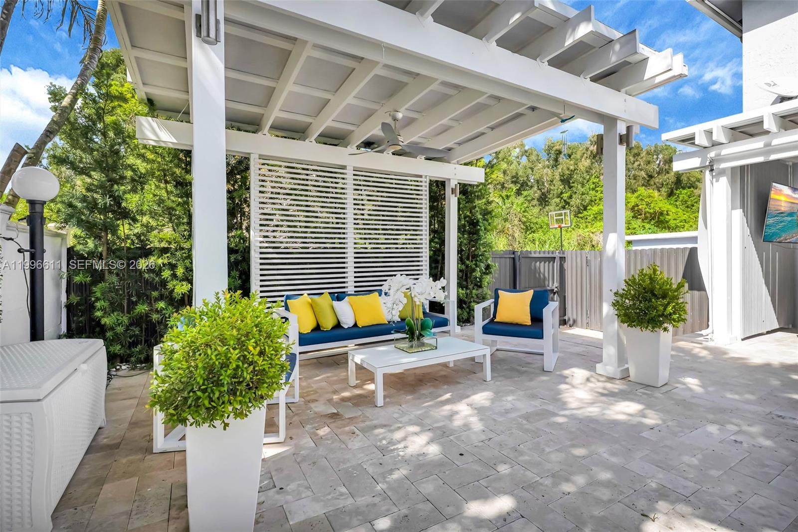 3002 Southwest 147th Court Miami, FL 33185 - Photo 6 of 97 a view of a patio with table and chairs and potted plants
