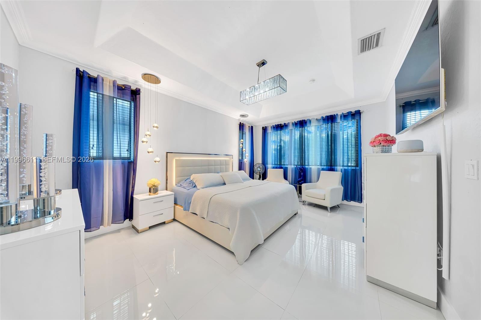 3002 Southwest 147th Court Miami, FL 33185 - Photo 62 of 97 a bedroom with a large bed and a chandelier