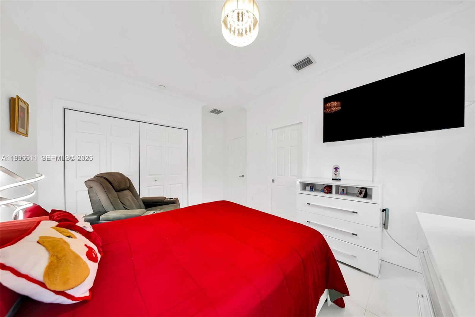 3002 Southwest 147th Court Miami, FL 33185 - Photo 63 of 97 a bedroom with a bed and a flat screen tv