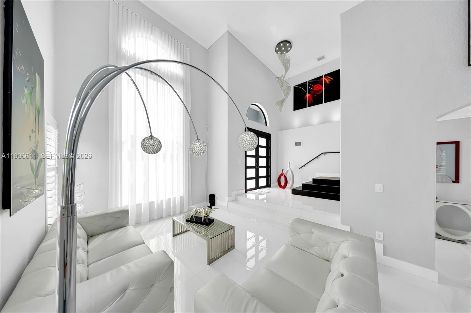 3002 Southwest 147th Court Miami, FL 33185 - Photo 68 of 97 a living room with furniture and a mirror