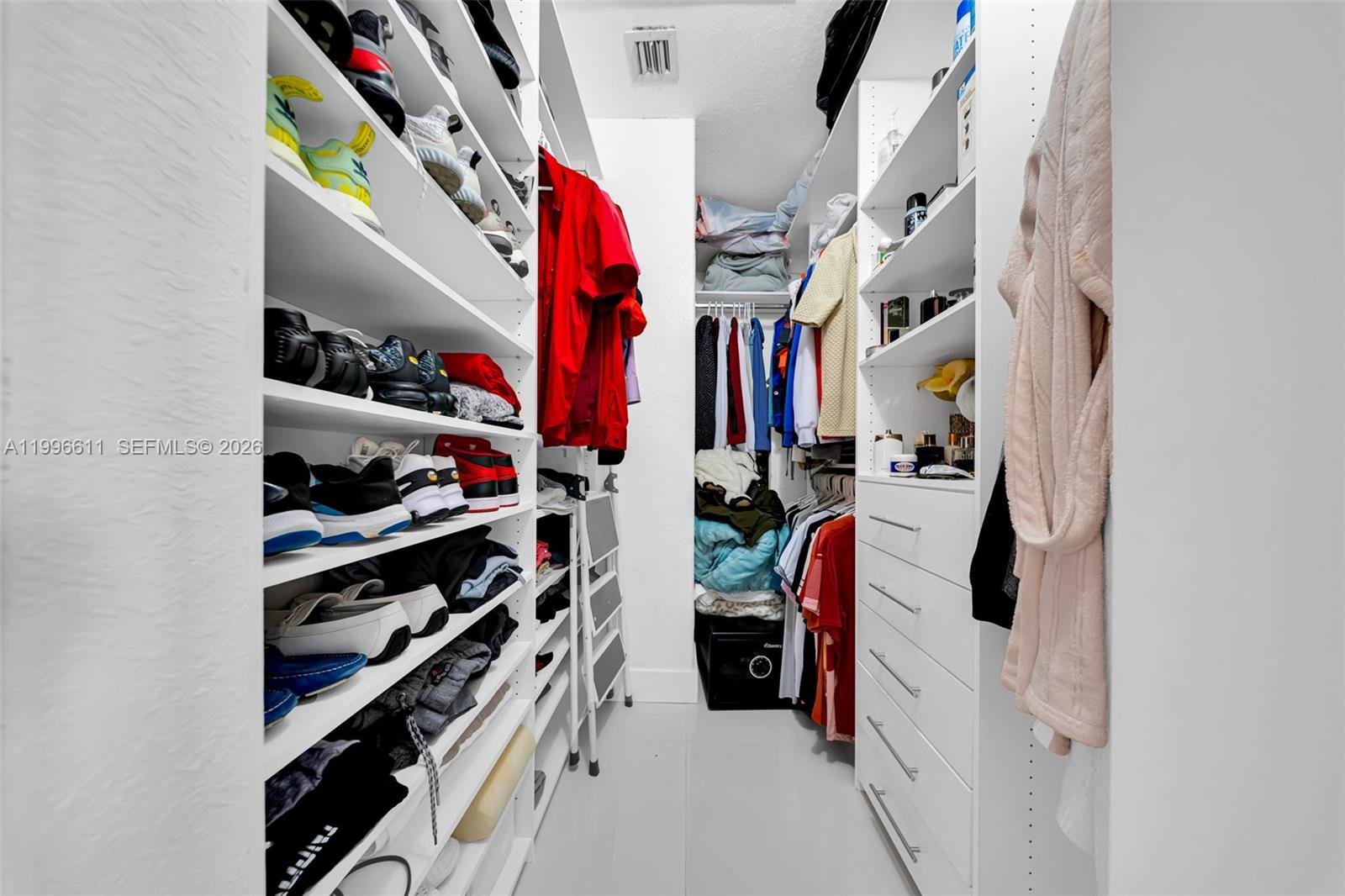 3002 Southwest 147th Court Miami, FL 33185 - Photo 69 of 97 a view of walk in closet with clothes and shoes