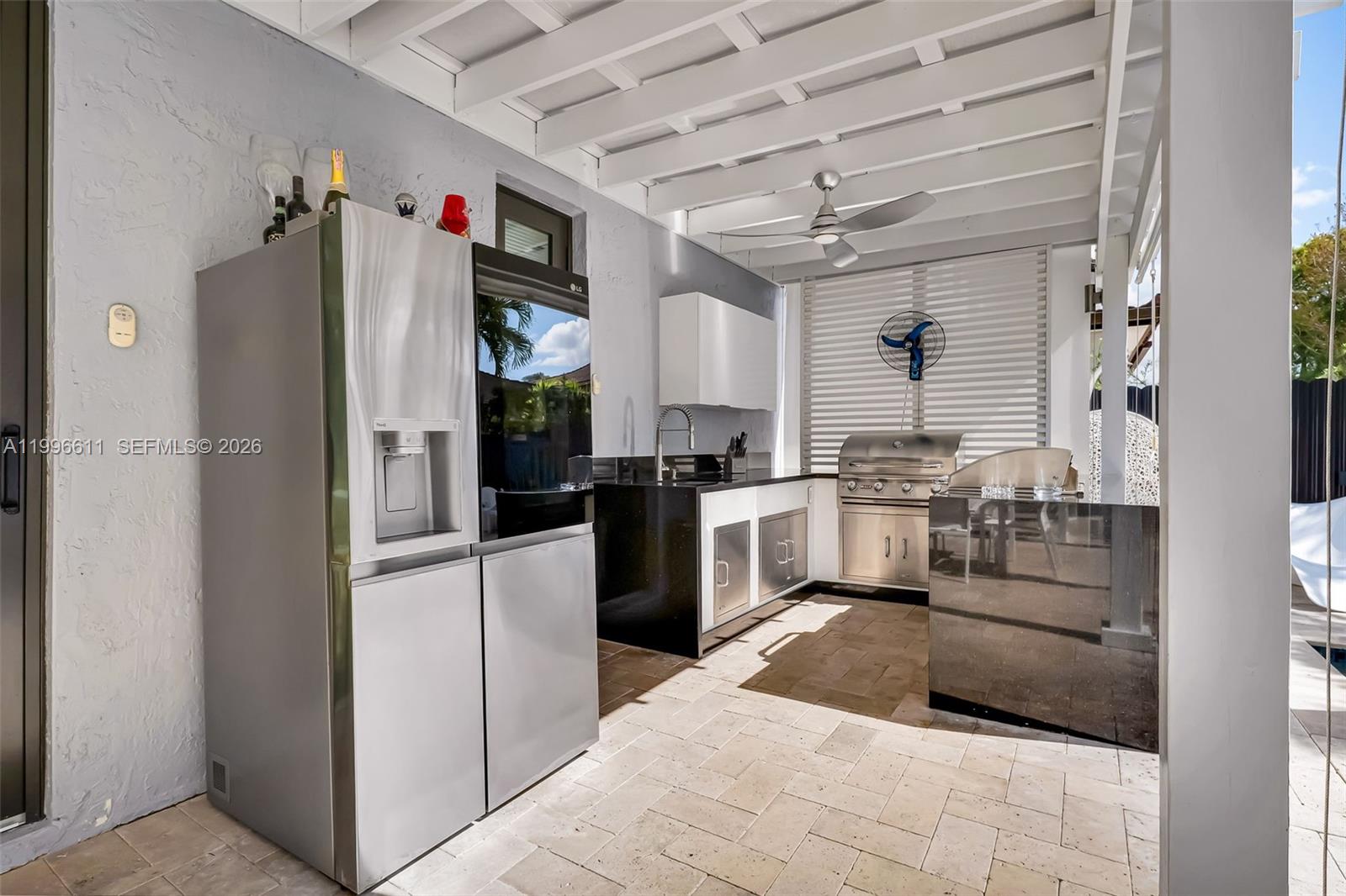 3002 Southwest 147th Court Miami, FL 33185 - Photo 72 of 97 a kitchen with stainless steel appliances kitchen island granite countertop a refrigerator and a sink