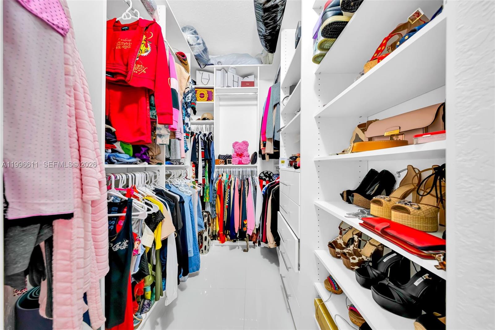 3002 Southwest 147th Court Miami, FL 33185 - Photo 78 of 97 a view of walk in closet with clothes and shoes