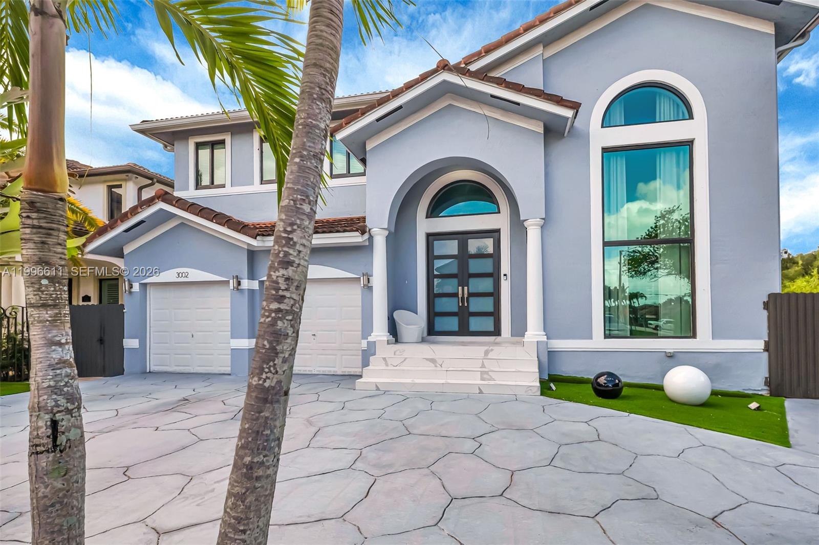 3002 Southwest 147th Court Miami, FL 33185 - Photo 83 of 97 a front view of a house with a yard and potted plants