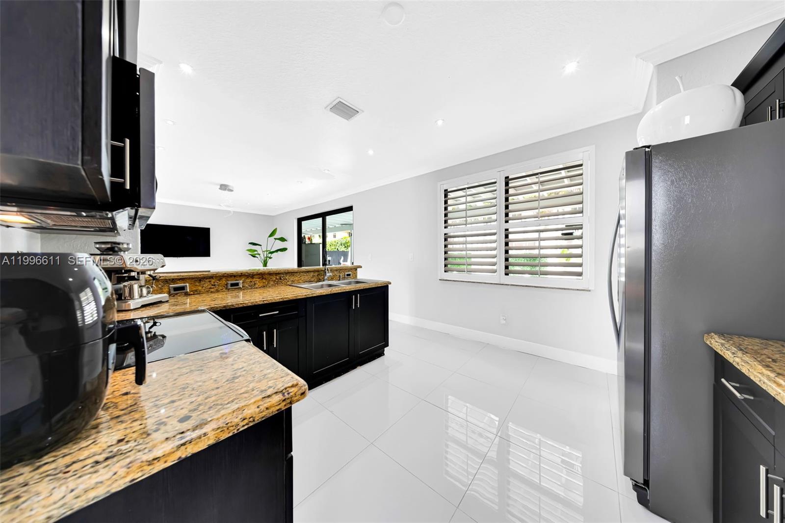 3002 Southwest 147th Court Miami, FL 33185 - Photo 91 of 97 a kitchen with a refrigerator and a counter top space