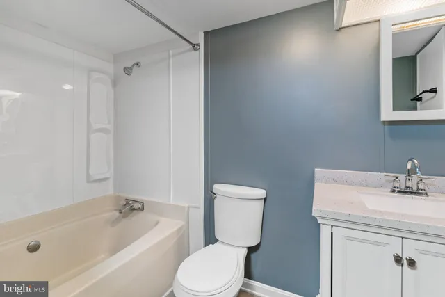 a bathroom with a sink toilet and bathtub