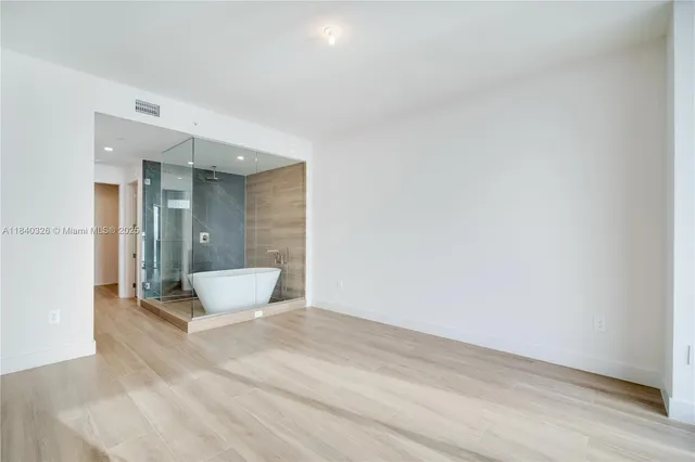 a white bath tub sitting next to a white sink