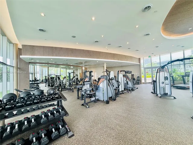a view of a tennis ground with large trees