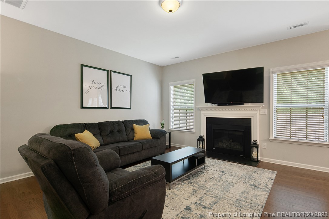 233 Blue Bay Lane Cameron, NC 28326 - Photo 11 of 50 a living room with furniture a flat screen tv and a fireplace
