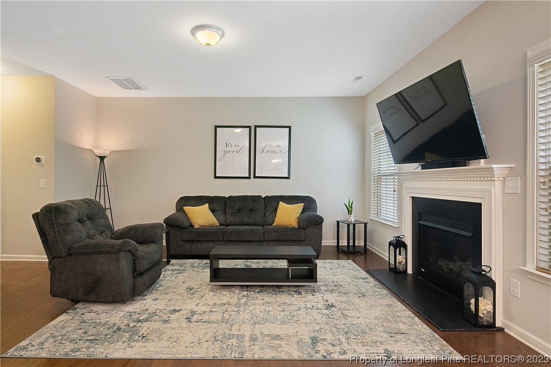 233 Blue Bay Lane Cameron, NC 28326 - Photo 12 of 50 a living room with furniture a flat screen tv and a fireplace