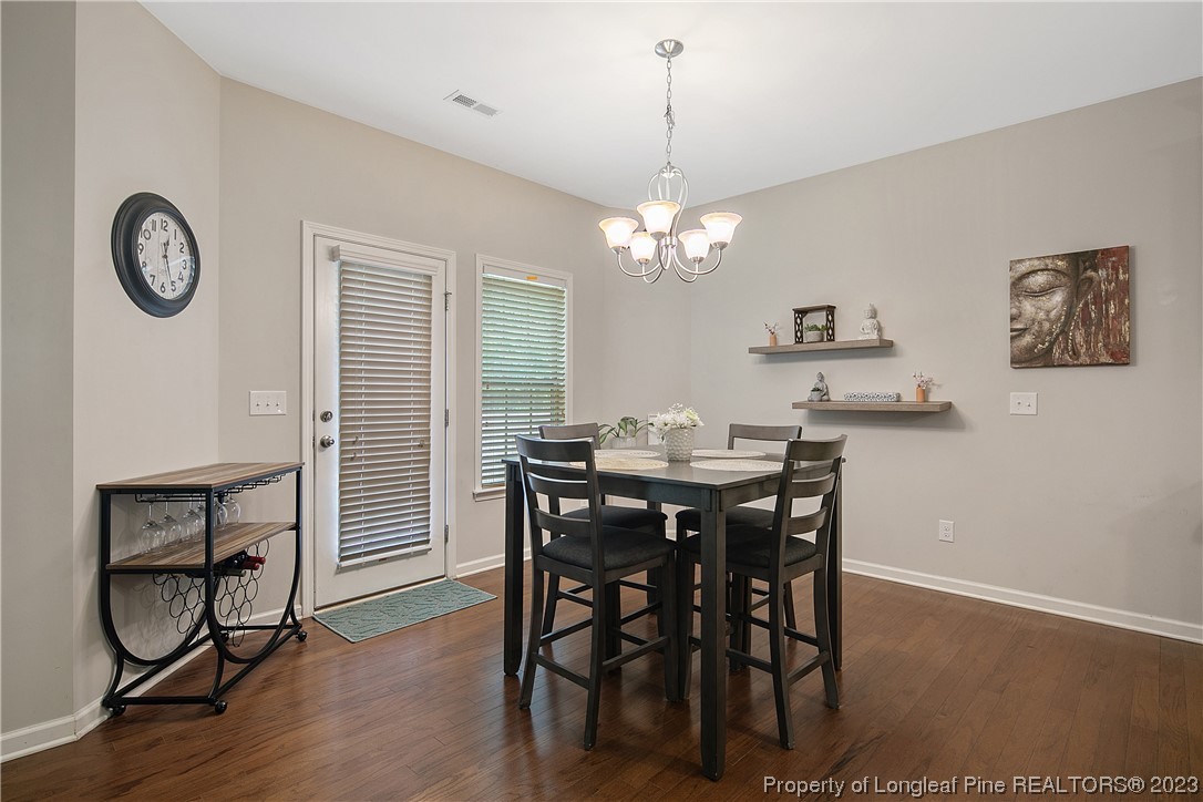 233 Blue Bay Lane Cameron, NC 28326 - Photo 16 of 50 a view of a dining room with furniture and wooden floor