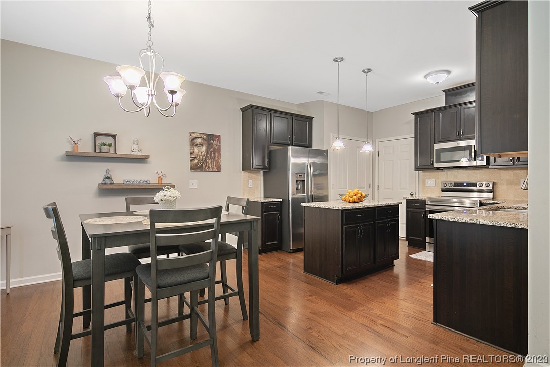 233 Blue Bay Lane Cameron, NC 28326 - Photo 17 of 50 a kitchen with stainless steel appliances kitchen island granite countertop a dining table chairs and a refrigerator