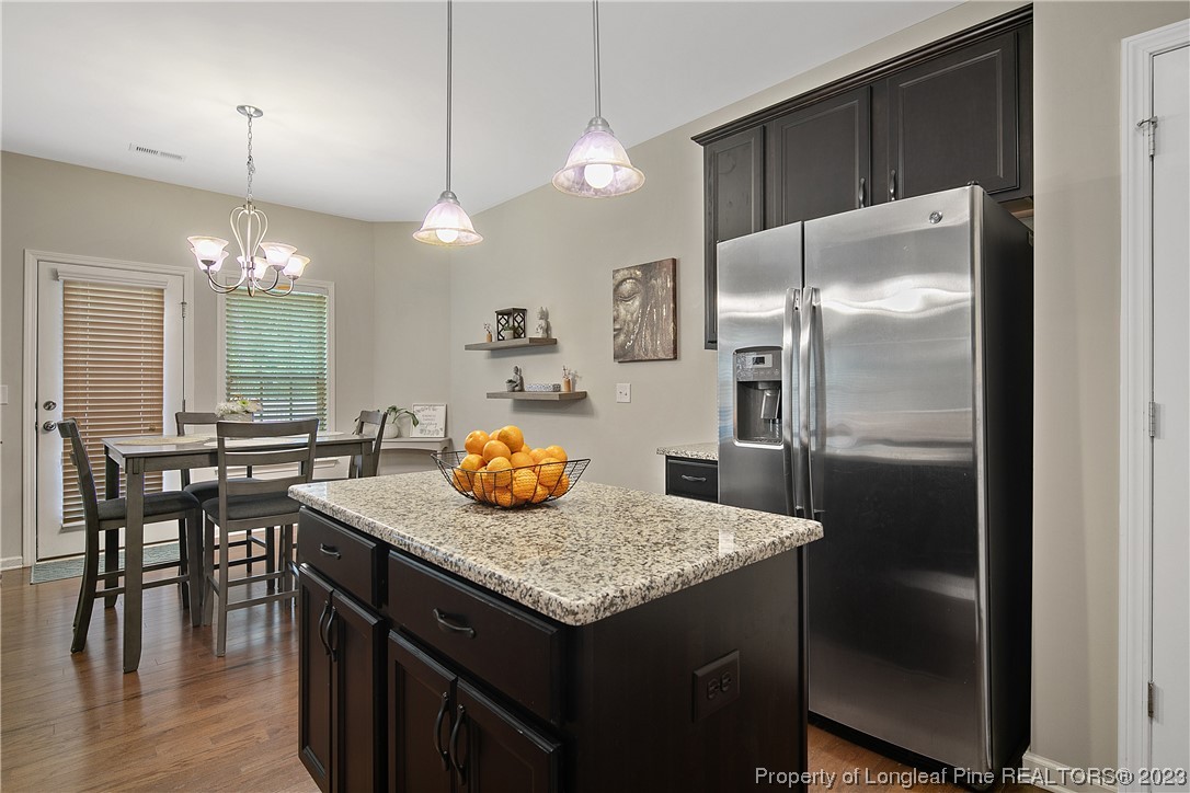 233 Blue Bay Lane Cameron, NC 28326 - Photo 20 of 50 a kitchen with stainless steel appliances granite countertop a kitchen island hardwood floor and a sink