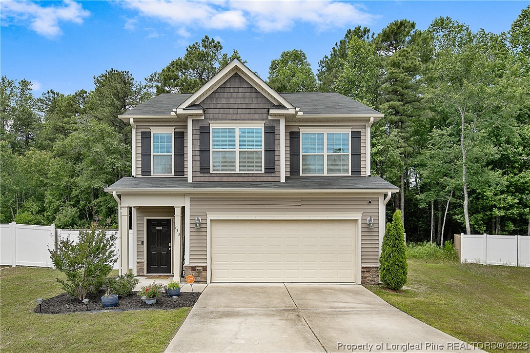 233 Blue Bay Lane Cameron, NC 28326 - Photo 2 of 50 a front view of a house with a yard and garage