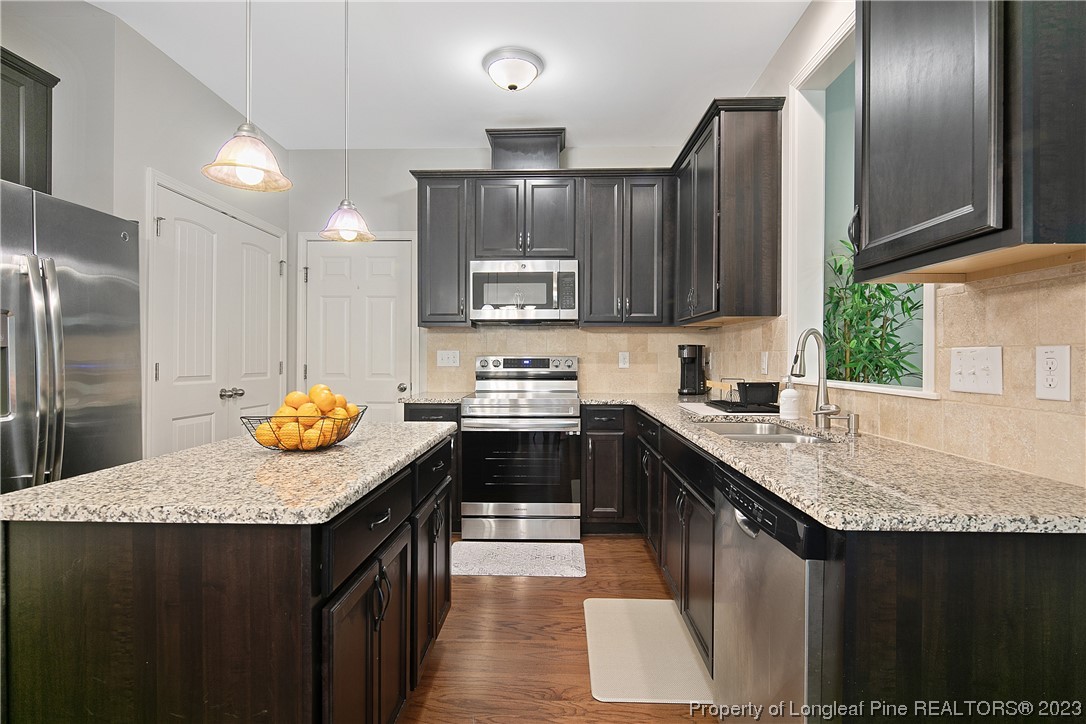 233 Blue Bay Lane Cameron, NC 28326 - Photo 25 of 50 a kitchen with granite countertop a sink a stove and refrigerator