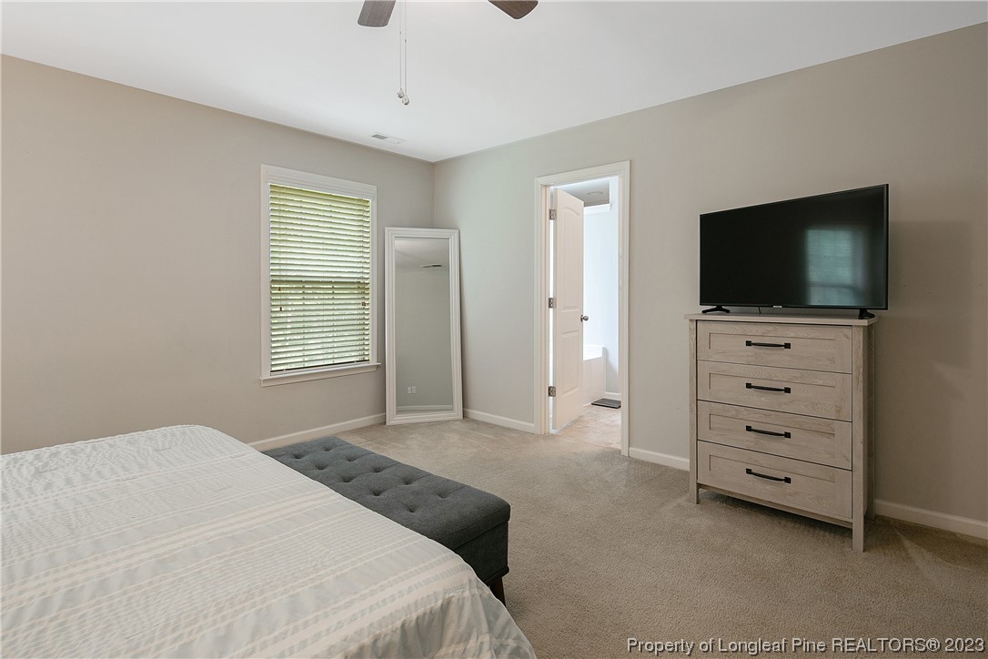 233 Blue Bay Lane Cameron, NC 28326 - Photo 29 of 50 a bedroom with a bed and a flat screen tv